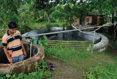   -The two large tanks in this photo A) use manure,water,and anaerobic bacteria to produce biogas. B) use manure,water,and aerobic bacteria to produce biogas. C) burn unused parts of crop plants to generate heat for homes. D) collect and stores carbon dioxide in underground wells.