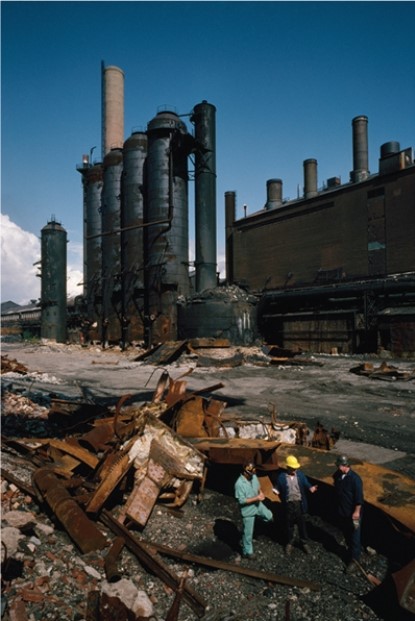 For this question,refer to the following photograph of an old steel mill being demolished during the 1980s.   The photograph above best serves as evidence of A)  increasing economic inequality in the United States. B)  the major environmental challenges that faced the United States. C)  intensified debates over free-trade agreements. D)  economic challenges stemming from integration of the United States into the world economy.