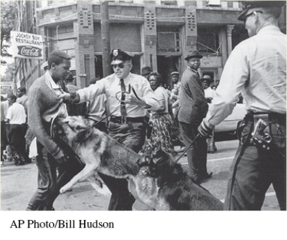 For this question,refer to the following photograph of police in Birmingham,Alabama,using dogs against peaceful African American protesters in 1963.   Which events of the late twentieth and early twenty-first century represent a continuation of the process depicted by this image? A)  Debates about identity and gender roles as matters of social justice B)  Intensified public debates over the size and scope of the social safety net C)  The increase in economic inequality as union membership declined and immigration increased D)  Reduced public faith in the government's ability to solve social and economic problems