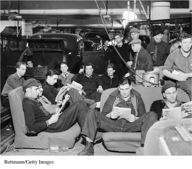 For the following question,refer to the following photograph of a United Auto Workers strike in Flint,Michigan,on January 9,1937.   The activities depicted in the photograph above reflect most directly A)  new technologies contributing to improved standards of living. B)  the transformation of the United States into a limited welfare state. C)  political and cultural conflicts between management and labor. D)  the persistence of poverty as a national problem.