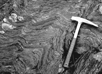 Banded-iron formations,such as the one in the image below,show evidence of an   A)  oxygen-poor atmosphere because all of the oxygen was dissolved into the oceans and then precipitated as iron-oxide minerals. B)  acidic ocean that forced iron to bond with the oxygen in the water to form iron-oxide minerals. C)  oxygen-poor ocean because all the oxygen was trapped in the iron-oxide minerals that make up the formation. D)  oxygen-rich atmosphere that forced the oceans to become oxidizing and precipitate iron-oxide minerals.