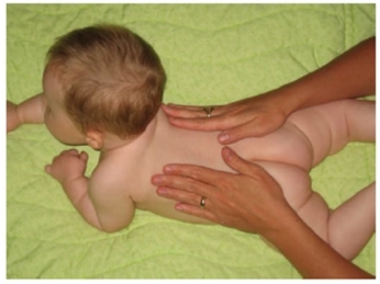 During a home visit the nurse observes a new mother performing the following action. What should the nurse document that the mother is doing with the child? A) Massage B) Acupressure C) Biofeedback D) Moxibustion