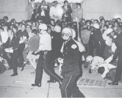 Riots at the 1968 Democratic national convention   Credit: Michael Boyer/AP Images -Which of the following political events was the site of this massive protest in 1968? A) political caucus B) Electoral College -Consider This: The Electoral College happens after the popular presidential election and doesn't receive media coverage like conventions. C) national party convention D) presidential primary