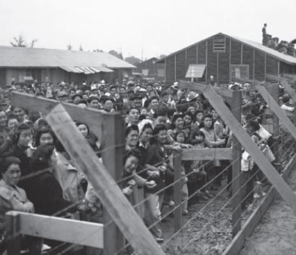    Credit: Library of Congress/Corbis Historical/VCG/Getty Images -Based on this photograph,how were Japanese Americans treated during World War II? A) They received the same protections as other American citizens. B) German Americans were perceived as the greater threat.-Consider This: German Americans were also targeted as potential spies,but not to the same extent as the Japanese population on the West Coast. C) They were stripped of many legal and natural rights. D) Only adults were targeted as potential threats.