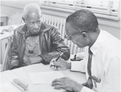 Implementation of the 1965 Voting Rights Act   Credit: Bettmann/Getty Images -Based on the image,which of the following aided implementation of the Voting Rights Act of 1965? A) federal registrars dispatched to Southern counties B) the support of Southern governors C) the spoils system D) the use of incentive systems -Consider This: When the typical forms of regulatory control failed to achieve results in the federal government's attempt to uphold African American voting rights in the South,a more direct method of bureaucratic intervention was utilized.