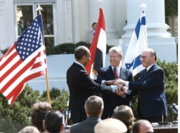    Credit: Carter Archives/ZUMA Press,Inc./Alamy Stock Photo -Which presidential power did Carter employ in negotiating the Camp David Accords? A) chief diplomat B) commander in chief -Consider This: Commander in chief refers more to the president's leadership in wartime than brokering peace between two other nations. C) war powers D) diplomatic envoys