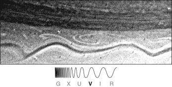 What is the long, snaking dark line found in the visible light image of Saturn shown below? Is there an analogous feature on Earth?  