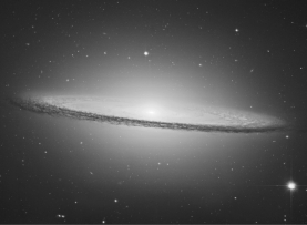 The dark features in the HST image in the figure shown below indicate   A)  collections of cool stars. B)  clumps of dark matter. C)  copious amounts of dark energy. D)  large amounts of dust. E)  faulty pixels on the CCD camera.