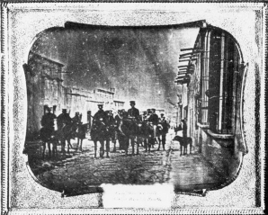    -How does Nathaniel Currier's lithograph on the right portraying the death of Colonel Henry Clay Jr. at the Battle of Buena Vista during the Mexican War differ from the daguerreotype on the left of Brigadier General John E. Wool and his staff in Saltillo, Mexico? A)  The lithograph attempts to portray events accurately, whereas the daguerreotype is simple propaganda. B)  The lithograph is inspirational, whereas the daguerreotype is realistic. C)  The lithograph was made for Clay's family, whereas the daguerreotype was distributed for public consumption. D)  The lithograph celebrates war, whereas the daguerreotype criticizes it.
