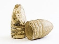     -How did the newly-developed minie balls, which are pictured on the left, change warfare as compared to the more traditional musket balls, which are featured on the right? A)  They were designed to inflict minimal damage to a victim. B)  Their design made it possible to hit a target at a greater distance. C)  They were less expensive to produce. D)  They were easier to ship to the front lines of battle.