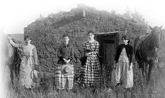 <strong> What does this photograph of the four Chrisman sisters standing in front of their sod home in Custer County, Nebraska, reveal about life on the Great Plains?</strong> A) Homesteading was often accompanied by the challenges of loneliness and drudgery. B) Sod homes and dugouts offered basic amenities like running water and glass windows. C) Single women were often more successful at homesteading than single men or families. D) Farming on homesteads was profitable because of mild weather conditions and fertile soil.