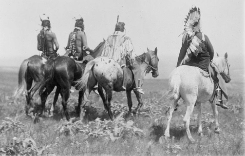 <strong> Why did photographer Edward Curtis choose to portray many of the Native Americans, such as these Crow warriors, as figures riding off into the distance in his ethnographic project The North American Indian?</strong> A) He wanted to publicize their skills as horsemen. B) He wanted to show that many Indian cultures were already on the verge of disappearing. C) He wanted to capture the variety and richness of Native American culture. D) He wanted to keep the public aware of the problems related to forced assimilation.