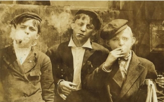 <strong> How might Progressives' reactions to Lewis Hine's Sadie Pfeiffer, Lancaster Cotton Mills, South Carolina have differed from their reactions to his photo Newsies Smoking on a Monday Morning, St. Louis, Missouri, 1910?</strong> A) Progressives probably would have been angry that the little girl was standing idle but amused at the young boys' antics. B) Progressives probably would have been accepting of the little girl's working under adult supervision but angry that three young boys were working without such supervision. C) Progressives probably would have felt protective of the little girl working practically alone in the big factory but would have been upset by the vice of the young boys. D) Progressives probably would have feared what the future held for the young boys but would not have been as concerned about the future of the little girl.
