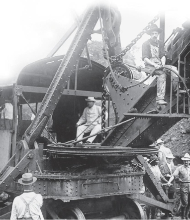 <strong> How does this photograph of President Theodore Roosevelt working the controls of a steam shovel in the Panama Canal Zone exemplify the spirit of imperialism that took hold in the United States during the late nineteenth and early twentieth centuries?</strong> A) It is reflective of the democratic process that the United States used to acquire the Canal Zone from Colombia. B) It shows how technological innovation promoted overseas economic expansion and world prominence for the United States. C) It demonstrates the lack of sensitivity shown to native laborers who were considered to be racially and culturally inferior. D) It addresses the method used by Americans to civilize non-American lands and people.