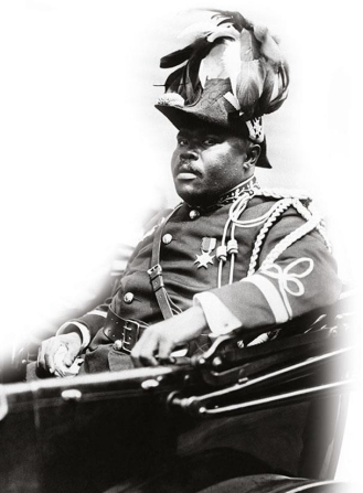 <strong> Why did Marcus Garvey choose to appear in full military regalia and plumed hat as the founder and leader of the Universal Negro Improvement Association?</strong> A) He wanted to emphasize his background as a veteran of World War I. B) He believed that wearing such a uniform would challenge the white stereotype of racial subservience. C) He wanted to prove to his followers that he was much more militant than Booker T. Washington. D) He desired to rule Liberia as a monarch once African Americans resettled there.
