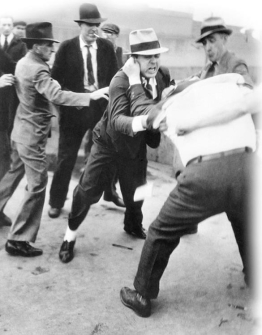 <strong> Why did photographs such as this one taken at the Ford motor plant in Dearborn, Michigan, cause a public outcry?</strong> A) They revealed the rough tactics often employed by union organizers. B) They showed how sit-down strikes often turned violent. C) They showed the brutality of Ford security forces against union organizers. D) They revealed the tensions between AFL and CIO members.