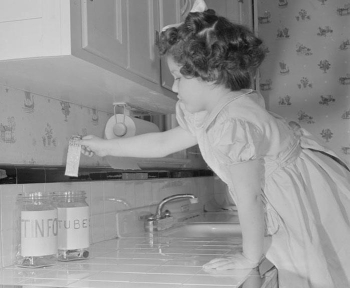     -These two photographs depicting American children shopping with ration books and collecting metal for local scrap drives during World War II reveal that . A)  scarcity impacted many American families B)  overproduction led to more expensive goods in markets C)  propaganda had little impact on American children D)  children played a marginal patriotic role on the home front