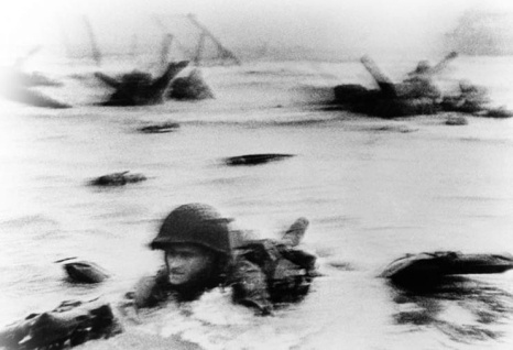   -Although Life magazine photographer Robert Capa's images of the 1944 D-Day invasion accidentally came out blurred after a darkroom technician used too much heat to dry the film, this grainy image became iconic because it . A)  captured the chaos and danger faced by American soldiers on the beaches of Normandy B)  showed how easy the victory at Normandy was for Allied troops C)  depicted the ineffective German strategy of defending its beachhead in Normandy D)  revealed that the Normandy invasion was a diversion from a bigger invasion further north