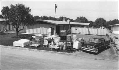     -These two 1955 photographs of a suburban middle-class family called  What They Have  vs.  What They Own  featured in Life magazine demonstrate that American families . A)  moved to suburbs in great numbers B)  relied heavily on credit to maintain affluent lifestyles C)  were made up of a white-collar working father and a stay-at-home mother D)  benefitted greatly from New Deal and Fair Deal programs