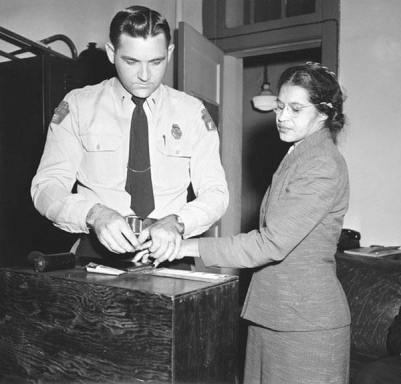<strong> What does this photograph of Rosa Park's 1955 arrest most accurately reveal about her role in instigating the Montgomery Bus Boycott?</strong> A) She was part of a well-organized movement that the NAACP led to test the bus segregation law. B) She was simply a tired seamstress who impulsively decided to stay seated when asked to move. C) She decided to participate in a planned one-day bus boycott to avoid potential violence. D) She was violently beaten in jail after her arrest.