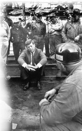 <strong>  What did 1960 Democratic presidential candidate John F. Kennedy mean when he stated that he was better off in the war [World War II] than they are in the coal mines when he met with coal miners in West Virginia during his campaign?</strong> A) Coal miners in West Virginia faced harsh consequences if they went on strike for better working and living conditions. B) Pesticides had ruined the West Virginia terrain so that farming was nearly impossible and led to hunger for mining families. C) West Virginians had to deal with numerous environmental hazards that jeopardized their health. D) The miners and their families had to deal with appalling poverty in their lives. <div style=padding-top: 35px> 
