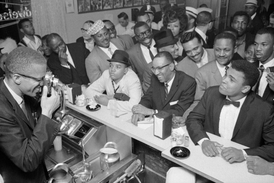 <strong> This image of Malcolm X, who is shown on the left, taking a photograph of heavyweight boxing champion Muhammad Ali in 1964 kept white Americans on edge because both men</strong> A) called for violent attacks on whites B) used militant rhetoric emphasizing black pride and physical prowess C) advocated for a Islamic theocracy in the United States D) called for a Back-to-Africa movement