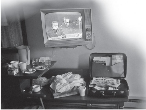 <strong> What was the irony captured by Life photographer Steve Schapiro's photograph of Martin Luther King Jr.'s room at the Lorraine Motel in Memphis when Schapiro took this snapshot several hours after King's assassination?</strong> A) King's book Strength to Love, which was in his suitcase, recommended that activists start to use violence to defend themselves. B) King had planned to return to his room that now featured a newscast about his death. C) King ate extravagantly for someone responsible for setting up the Poor People's Campaign. D) King was killed just outside of his motel room.