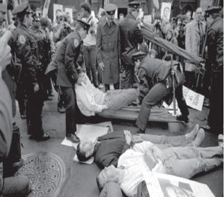 <strong> The AIDS Memorial Quilt and ACT-UP funeral demonstrations were similar in what way?</strong> A) Both used positive images to strive toward acceptance of gay lifestyles. B) Both were seen as subversive acts of civil disobedience. C) Both employed symbolism related to dead bodies. D) Both focused on demands for better care for AIDS patients.