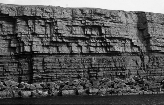 What type of phenomenon is demonstrated by the vertical lines in this picture?   A)  jointing B)  exfoliation C)  chemical weathering D)  hydration