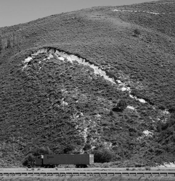 Examine the photograph below.What type of mass wasting event is beginning to take place here? How can you tell?  