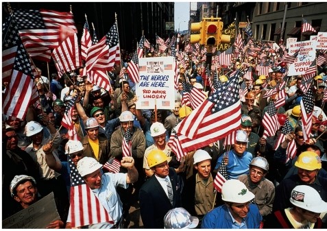 What can be inferred about the  hard hats  shown demonstrating in this image?   A)  They were antiwar student protestors. B)  They were pro-war student protestors. C)  They were pro-war union members. D)  They were antiwar union members.