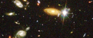 A frame of the HST deep field image of distant galaxies is shown.By means of optical and radio telescopes astronomers can see distant objects like these as they ...   A)  are right now. B)  will be in the distant future. C)  were in the distant past. D)  All of the above. E)  None of the above.