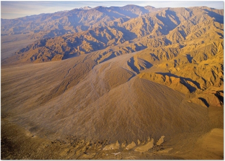   What desert landform is visible here? A) Inselberg B) Normal fault C) Playa lake D) Bajada