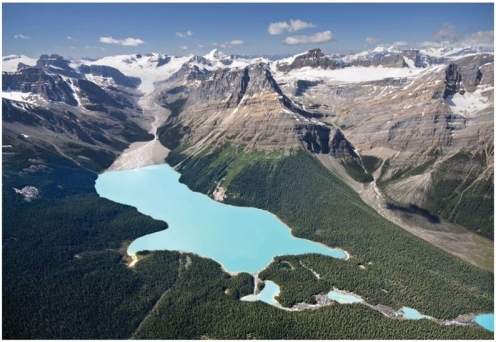   What substance is responsible for the turquoise color of the water in this image? A) Till B) Outwash C) Oxidation D) Rock flour