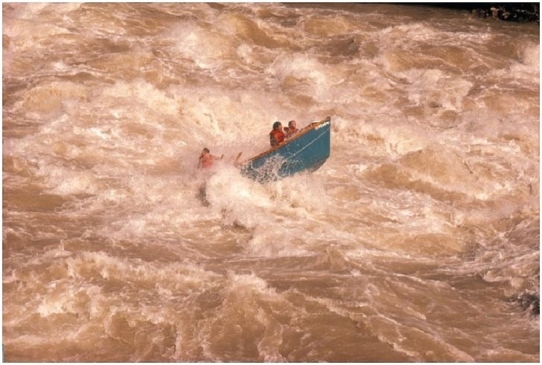   How will the flow in this image affect erosion of the stream channel? A) Water is moving so smoothly that the sediments are carried in the center of the water current B) Turbulent flow contributes to erosion because it lifts particles from the streambed C) Water flow is not strong enough to lift sediments, so erosion is minimal D) Erosion will occur near the head of the stream, but nowhere else
