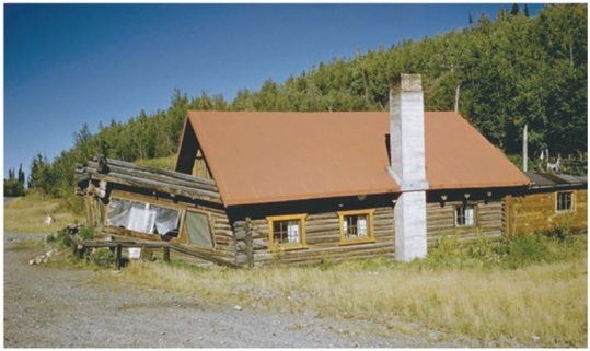   Assume this house is located in central Alaska.What did this house do to the local landscape to end up so misaligned? A) The house shifted because of a mudflow. B) The weight of the house generated a debris flow. C) A rockfall knocked the house off its foundation. D) Heat from the house melted the permafrost below.