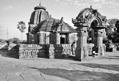 Questions refer to the images below. Image 1: Small Hindu temple in eastern India, tenth century   Image 2: Angkor Wat, built by the Khmer Empire   -Which of the following is the MOST likely explanation for the similarity between the architecture in the two images? A)  The Khmer rulers adopted the religion and style of Vedic temples in India. B)  Knowledge of Buddhist art and architecture followed the trade routes. C)  Nestorian Christians brought the knowledge of creating monumental stone architecture from the Byzantine Empire. D)  Both sites reflect the temple architecture of Arab Muslim merchants.
