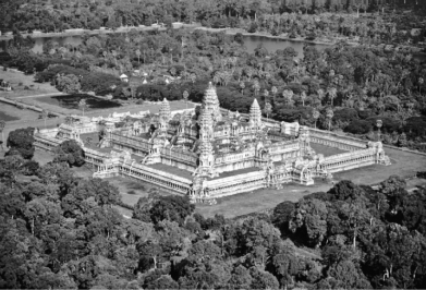 Questions refer to the images below. Image 1: Small Hindu temple in eastern India, tenth century   Image 2: Angkor Wat, built by the Khmer Empire   -Which of the following is the MOST likely explanation for the similarity between the architecture in the two images? A)  The Khmer rulers adopted the religion and style of Vedic temples in India. B)  Knowledge of Buddhist art and architecture followed the trade routes. C)  Nestorian Christians brought the knowledge of creating monumental stone architecture from the Byzantine Empire. D)  Both sites reflect the temple architecture of Arab Muslim merchants.