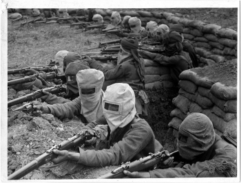 Questions are based on the following image. Indian infantry in the trenches at Fauquissart, France, 1915   -Which new technological development MOST led to the utilization of trench warfare? A)  Barbed wire B)  The airplane C)  The tank D)  The machine gun