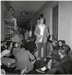The image  The Berkeley Free Speech Movement  shows student leader Mario Savio among other students in Sproul Hall at the University of California at Berkeley. What command of Savio's did the students seem to follow here?   A)   Put your bodies upon the gears.  B)   Trust no one over thirty.  C)   If some are not free, then none of us are free.  D)   The personal is political. 