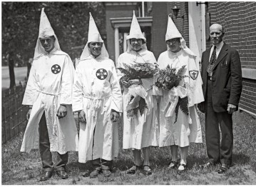 <strong>What does the image of the Ku Klux Klan wedding from 1925 (Document 21.2) reveal about the organization? </strong> A) It remained a southern organization. B) It remained predominantly rural. C) It had given up on white supremacist terrorism. D) It had become a socially acceptable public organization.
