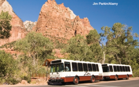 The two photographs below represent solutions to some of the threats faced by National Parks in the U.S. today. Describe the threat and explain how what is shown in the photo is a potential solution.   A   B
