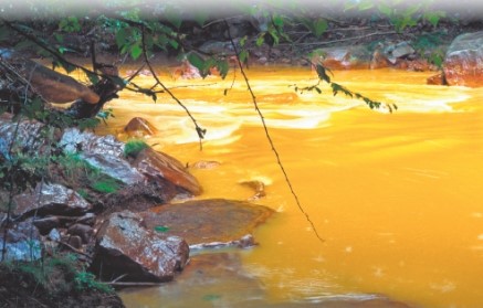 The two photos below show two different ways that mining contaminates the environment. Compare and contrast the specific ways that mining affects the environment in each case.   A   B