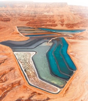 The two photos below show two different ways that mining contaminates the environment. Compare and contrast the specific ways that mining affects the environment in each case.   A   B