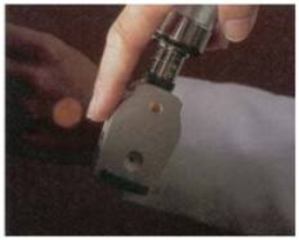 The medical assistant in the figure is shining the ________ light beam on her hand to check the strength of the beam.