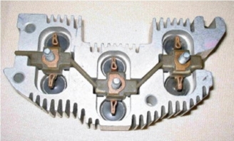 <strong>Identify this alternator component.  </strong> A)Rectifier bridge B)Diode trio C)Alternator end housing D)Stator linkage <div style=padding-top: 35px> 