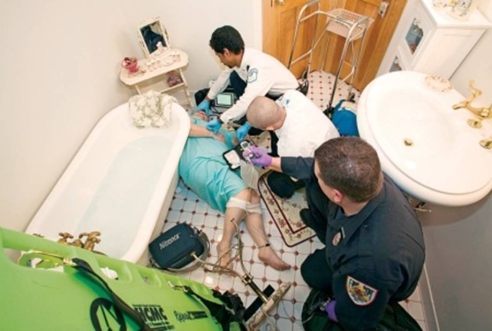 When transporting this patient to the ambulance, you should   A)  place her lying on her left side on a backboard. B)  use a fireman's carry to extricate her from the bathroom. C)  assist her in standing and let her use her walker. D)  use spinal precautions and place her on a backboard.