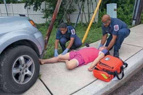 In this photo, the EMS personnel are involved in which phase of a typical EMS response?    A)  Dispatch/response B)  Detection of the emergency C)  Care during transport D)  On-scene care