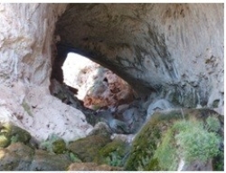 <strong>66)What type of feature is shown in this photograph? A stream flows through the feature and was involved in its formation.  </strong> A)natural bridge B)meteorite impact C)crescent dune D)natural arch E)none of these <div style=padding-top: 35px> 