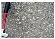 90) Which of the following photographs depicts an igneous rock where the magma cooled slowly at first and then had fast cooling? A)    B)    C)    D)   